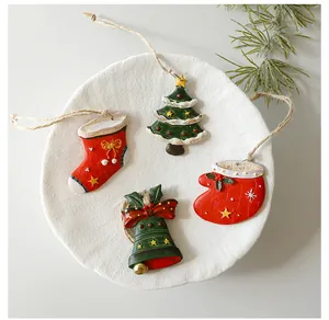 Detailed view of vintage Christmas tree and bell resin ornaments on a textured plate