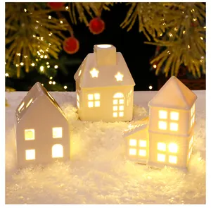 Cozy Nordic ceramic glowing houses with warm LED light for holiday Christmas decor.