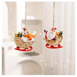 Hand-painted Christmas resin ornaments featuring Santa and Snowman in festive sleighs