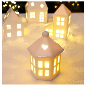 Macro view of a Nordic ceramic glowing house with warm LED light and heart cut-out