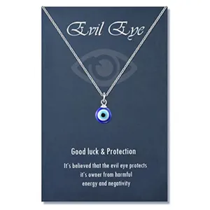 Traditional blue Evil Eye glass bead pendant necklace on protective message card