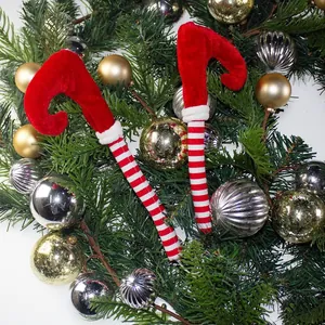 Pair of red and white striped Christmas elf leg candy cane picks for holiday tree decor