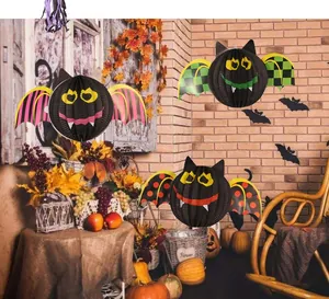 Halloween bat honeycomb paper lanterns hanging in a cozy rustic indoor decorative scene