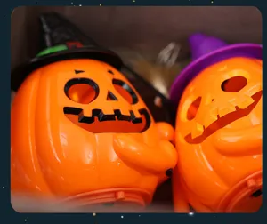 Close-up of orange Halloween pumpkin lanterns with colorful witch hats for party decor