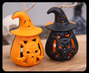Detail showing orange and black Halloween skull lanterns with witch hats on wood.