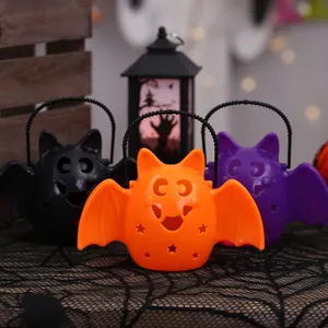 Set of Halloween bat-shaped candy buckets in orange, purple and black for party decor