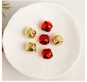 Detailed close-up showing red and gold metallic Christmas bells on a white plate