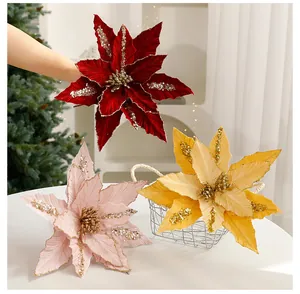 Detailed view of sequined artificial Christmas poinsettias in red gold and pink shades