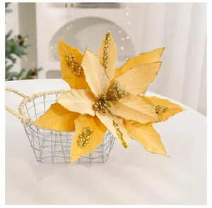Detailed view of gold artificial Christmas poinsettia with sparkling sequins and glitter.