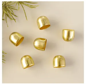 Macro detail of golden Christmas bell ornaments with a premium brushed metallic finish