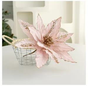 Close-up of pink artificial Christmas poinsettia with gold sequins and glitter details