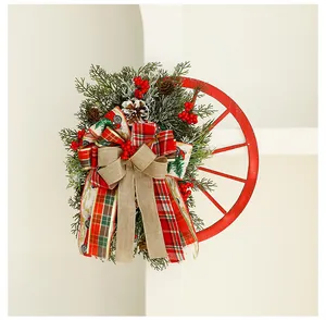 Detailed view of a Christmas wreath with a red wagon wheel and festive plaid ribbons.