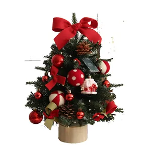 Festive mini PE Christmas tree with warm LED lights and red bow ornaments for desktop
