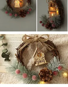 Detail shot of Christmas wreath with warm glowing wooden house and festive pine cones.