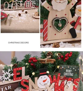 Detailopname van houten kerstversieringen met de Kerstman, sneeuwpoppen en feestelijke tekst.
