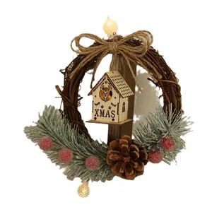 Traditional Christmas rattan wreath featuring a wooden house, pine needles and LED lights