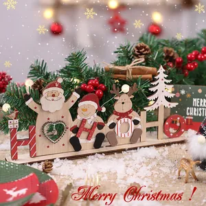 Feestelijke houten kersttafeldecoratie met de Kerstman, sneeuwpop en rendier.