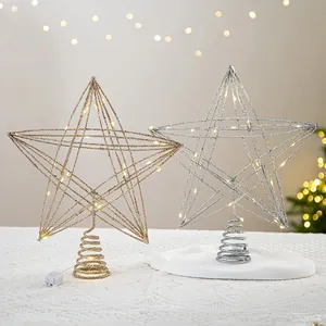 Sparkling gold and silver metal wire star Christmas tree toppers with warm LED lights.