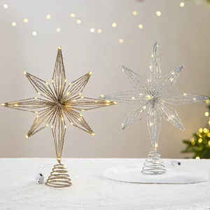 Golden and silver wire star Christmas tree toppers with warm LED lights festive decoration.