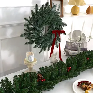 Realistic artificial Christmas wreath and garland set with red velvet ribbon