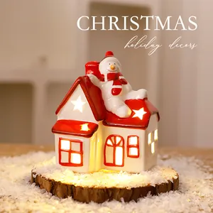Warm glowing Nordic ceramic Christmas house ornament with a cute snowman decor.