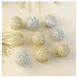 Macro detail of sparkly gold and silver metallic wire wrapped Christmas decorative balls