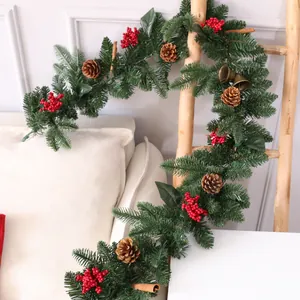 Festive Christmas garland with pine cones, red berries, and bells for holiday home decor.