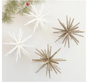 Close-up detail of elegant white and champagne gold glitter star ornaments for Christmas