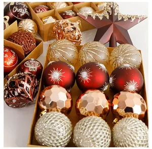 Close-up detail of coffee colored Christmas ornaments and star topper in kraft box