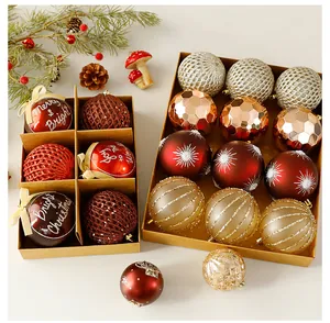 Assorted brown and gold Christmas ball ornaments presented in decorative kraft paper boxes
