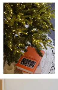 Close-up of warm LED firecracker lights draped on a lush Christmas tree.