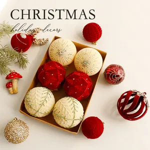 Set of red and cream flocked Christmas balls with glitter patterns in a gift box.