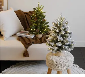 Detailed view of mini LED lighted Christmas trees in a cozy home living room setting