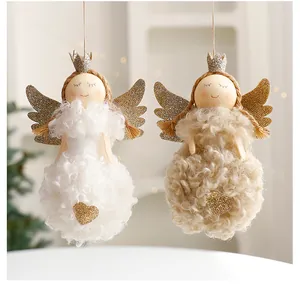 Detail of two plush Christmas angel dolls with glittery wings and golden crowns.