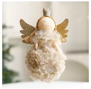 Close-up of a plush Christmas angel hanging ornament with glitter wings and crown
