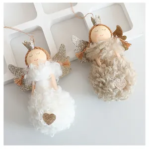 Detailed view of two cute Christmas angel doll ornaments with glitter wings and curly fur.