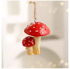 Close-up of a red mushroom Christmas hanging ornament with white spots and jute twine