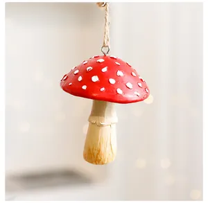 Detailed macro view of a red and white spotted mushroom Christmas ornament with jute string
