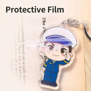 Detail view of cartoon police acrylic keychain showing protective film being peeled off