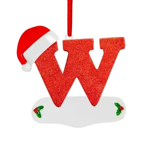 Close-up of a red glittery letter W Christmas tree ornament with a cute Santa hat