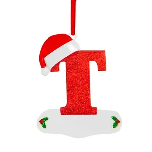 Detailed close-up of red glittery letter T Christmas tree ornament with a Santa hat