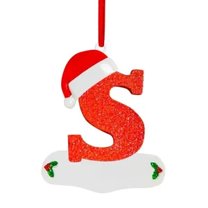 Close-up view of red glittery Christmas letter S ornament with a cute Santa hat.