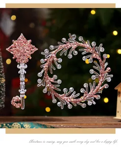 Close-up detail of pink glitter texture on transparent acrylic Christmas key and wreath