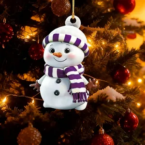 Cute cartoon snowman Christmas ornament hanging on a festive tree with warm lights