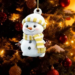 Adorable cartoon snowman ornament hanging on a festive warm lit Christmas tree branch