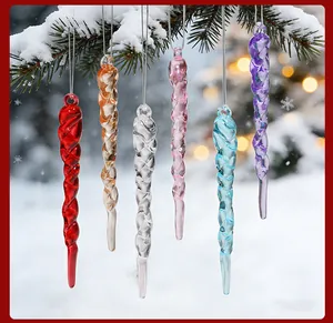 Close-up of colorful spiral acrylic icicle ornaments hanging on a snowy branch