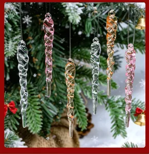 Clear and pink acrylic spiral icicle ornaments hanging on a snowy Christmas tree.
