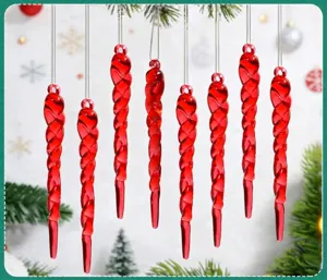 Detail of red acrylic spiral icicle ornaments hanging on a Christmas tree branch