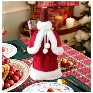 Festive red velvet Santa suit wine bottle cover on a decorated Christmas table
