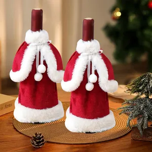 Festive red velvet Christmas wine bottle covers with white fur trim for holiday table decor